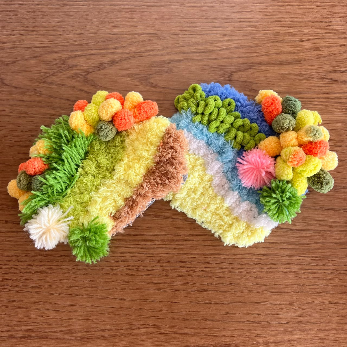 Two handmade moss coasters, one with a safari theme and one with a beach theme showing sun, sand, and sea. Set of two DIY kits by Otter's Art.