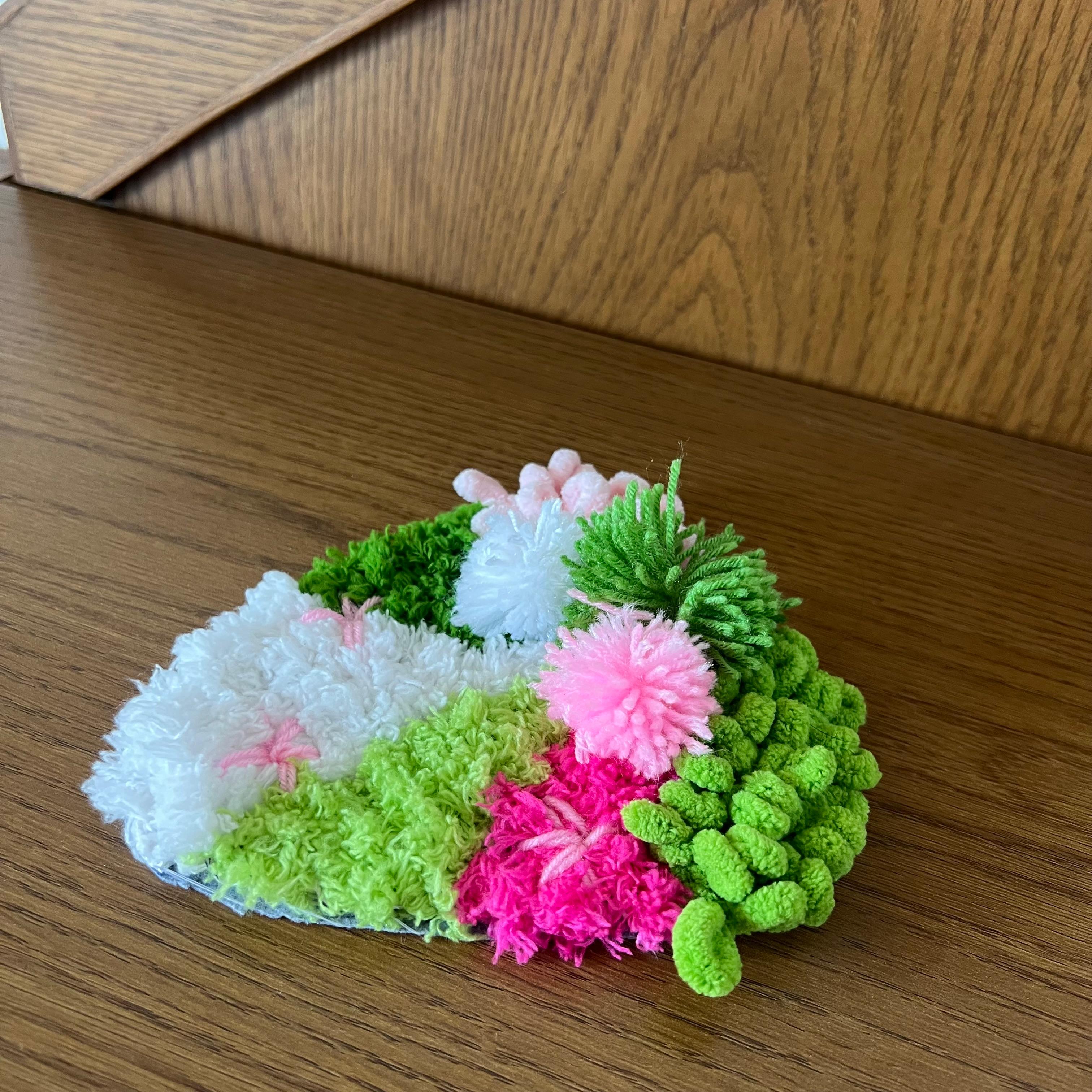 Finished Strawberry Matcha moss coaster, pink and green design.